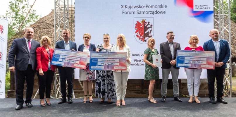 Wójt gminy Włocławek Magdalena Korpolak-Komorowska (w środku) symbolicznie odbiera dofinansowanie z budżetu województwa na przebudowę drogi w Gróbcach. Fot. UMWKP. 